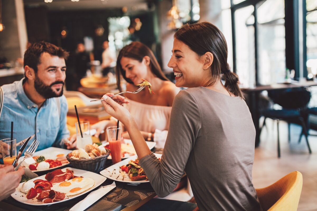 Friends in restaurant having food.