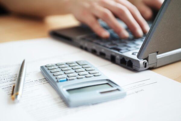 Office worker with calculator and laptop