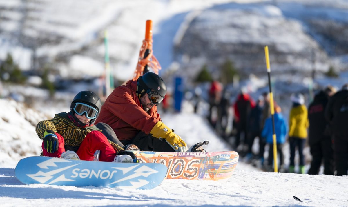 People with snowboards at Cairngorm Mountain