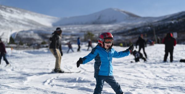 Child learning to snowboard